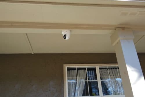 Exterior security camera mounted for wide-angle coverage
