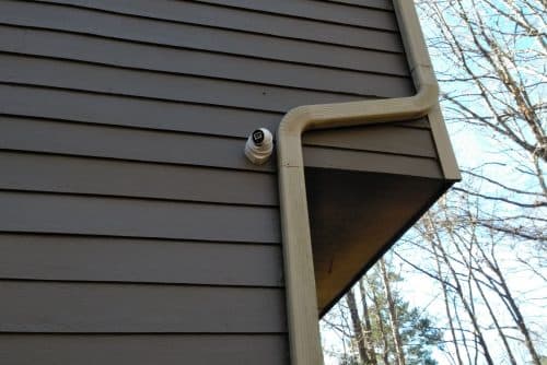 Outdoor home security camera mounted on exterior wall