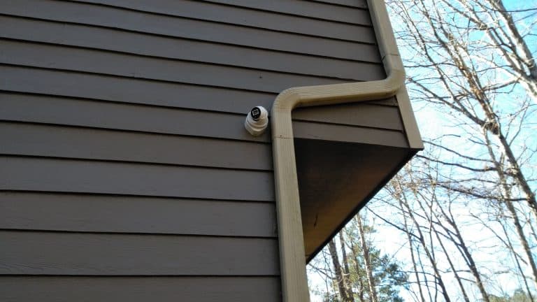 Outdoor home security camera mounted on exterior wall